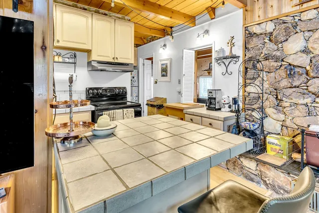 a dining room with furniture a chandelier and wooden floor