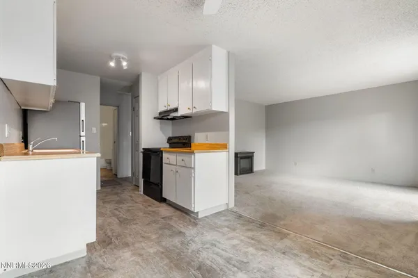 a kitchen with cabinets and a stove
