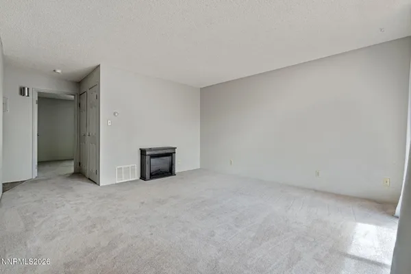 a view of an empty room with a fireplace