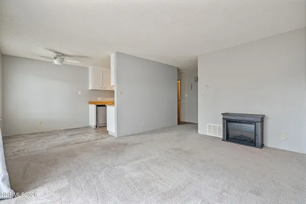 an empty room with a fireplace and window