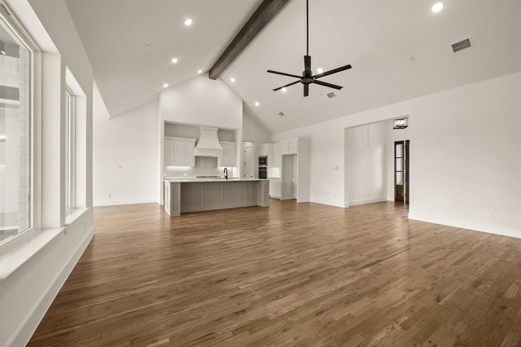 149 Highgate Court Boyd, TX 76023 - Photo 12 of 40 a view of empty room with wooden floor and ceiling fan