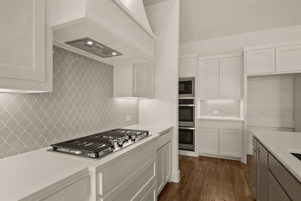 149 Highgate Court Boyd, TX 76023 - Photo 19 of 40 a kitchen with granite countertop a stove and a refrigerator