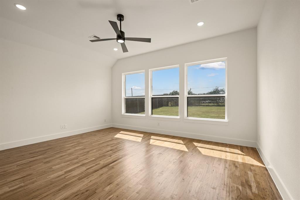 149 Highgate Court Boyd, TX 76023 - Photo 21 of 40 an empty room with wooden floor and windows