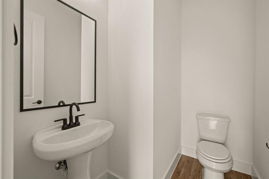 149 Highgate Court Boyd, TX 76023 - Photo 23 of 40 a bathroom with a sink a toilet and mirror