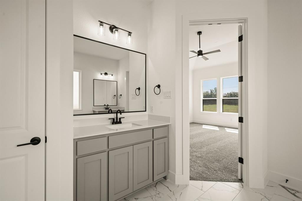 149 Highgate Court Boyd, TX 76023 - Photo 28 of 40 a bathroom with a shower sink and mirror