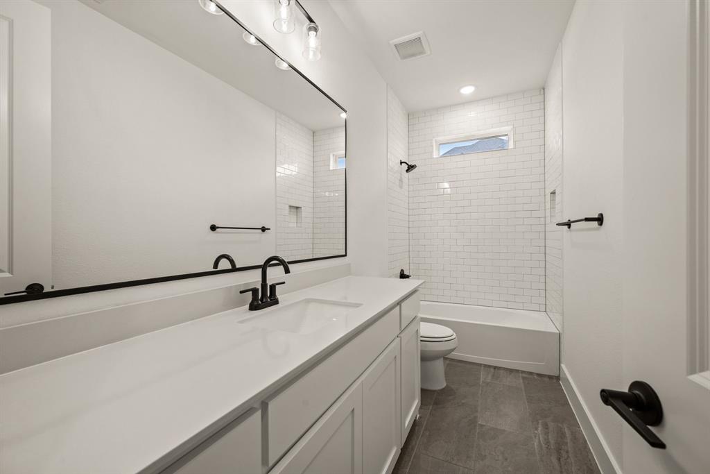 149 Highgate Court Boyd, TX 76023 - Photo 31 of 40 a bathroom with a sink a toilet a mirror and shower