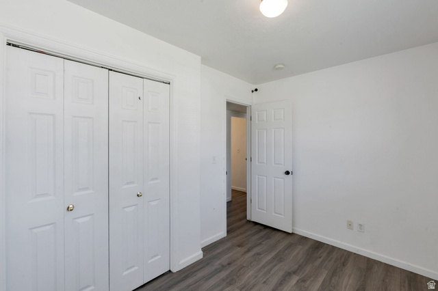 2013 West 460 South Provo, UT 84601 - Photo 15 of 24 Bedroom featuring wood-finish flooring, white walls, and bi-fold closet doors with gold-tone hardware
