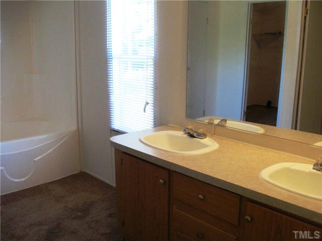 246 Skeet Range Road Coats, NC 27521 - Photo 11 of 20 a bathroom with a sink and a bathtub