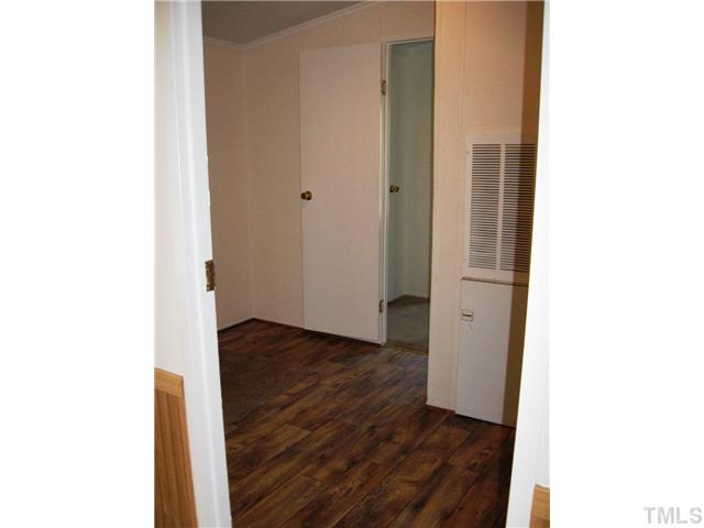246 Skeet Range Road Coats, NC 27521 - Photo 17 of 20 a view of a hallway with wooden floor