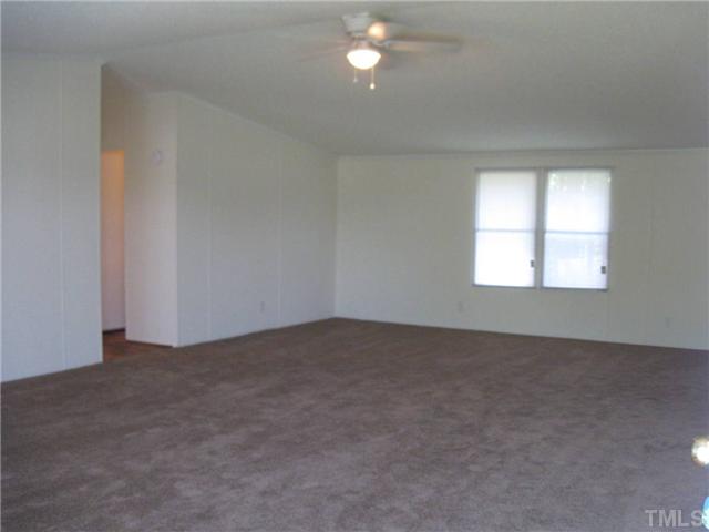 246 Skeet Range Road Coats, NC 27521 - Photo 2 of 20 an empty room that has a window