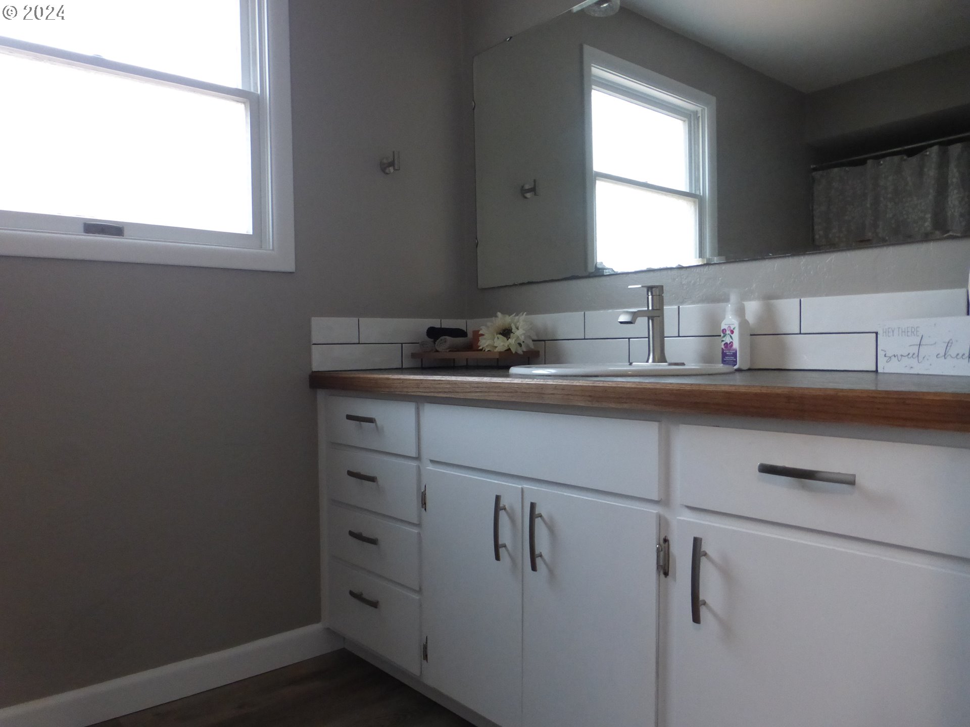 1026 M Street Springfield, OR 97477 - Photo 12 of 20 a bathroom with a sink and a window