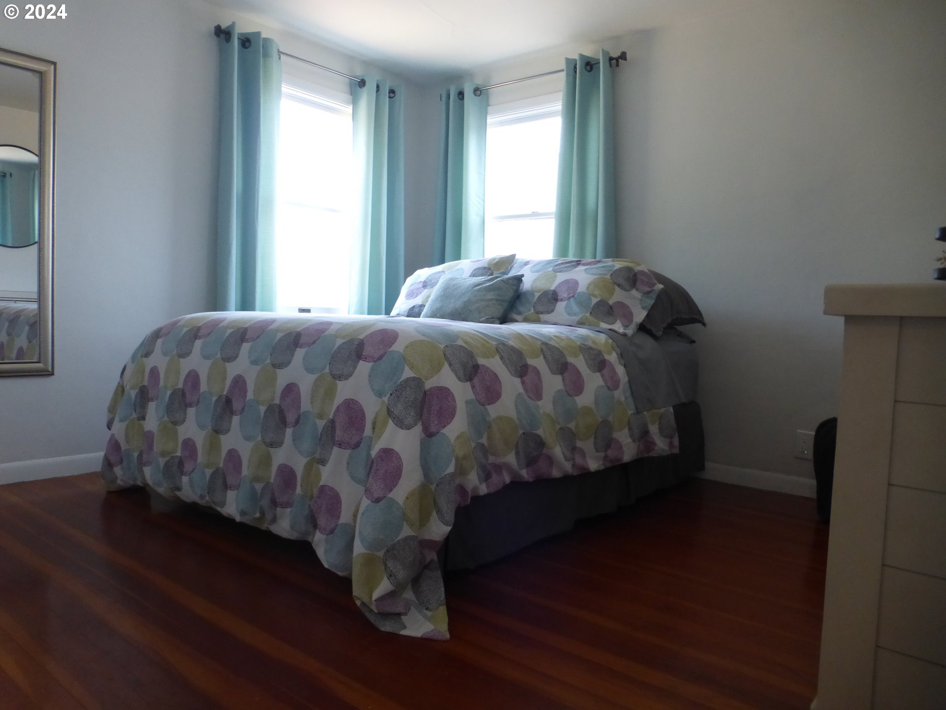 1026 M Street Springfield, OR 97477 - Photo 15 of 20 a bed sitting in a bedroom next to a window