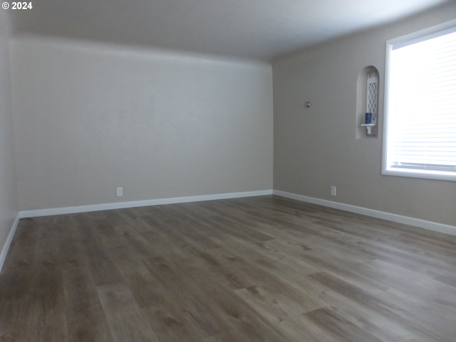 1026 M Street Springfield, OR 97477 - Photo 17 of 20 an empty room with wooden floor and windows