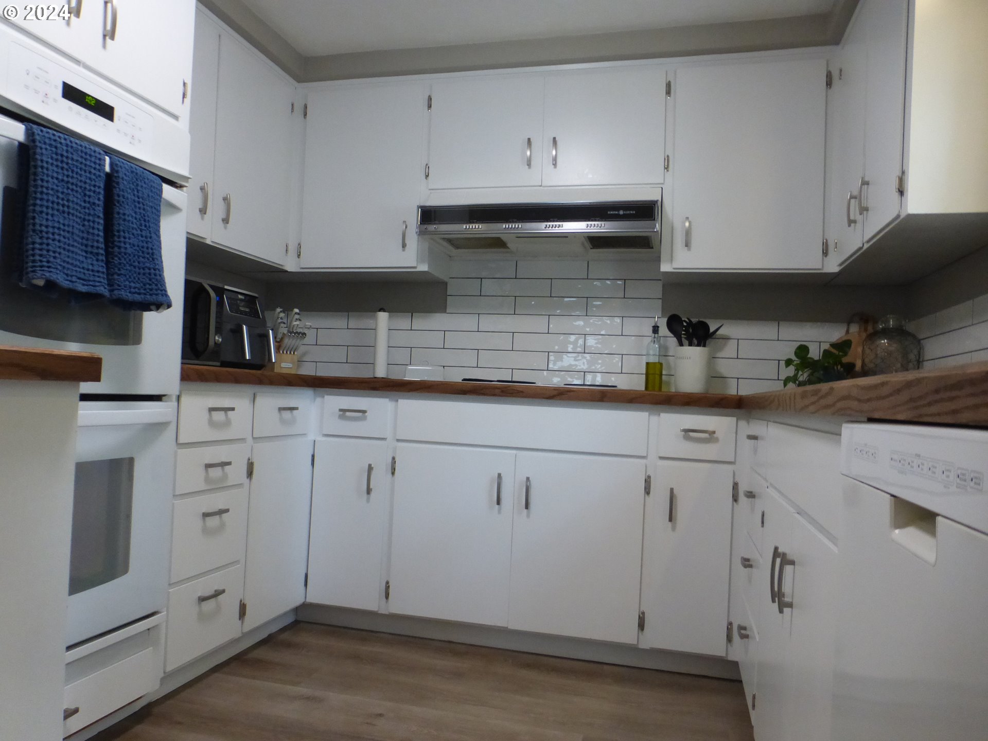 1026 M Street Springfield, OR 97477 - Photo 6 of 20 a kitchen with white cabinets and sink