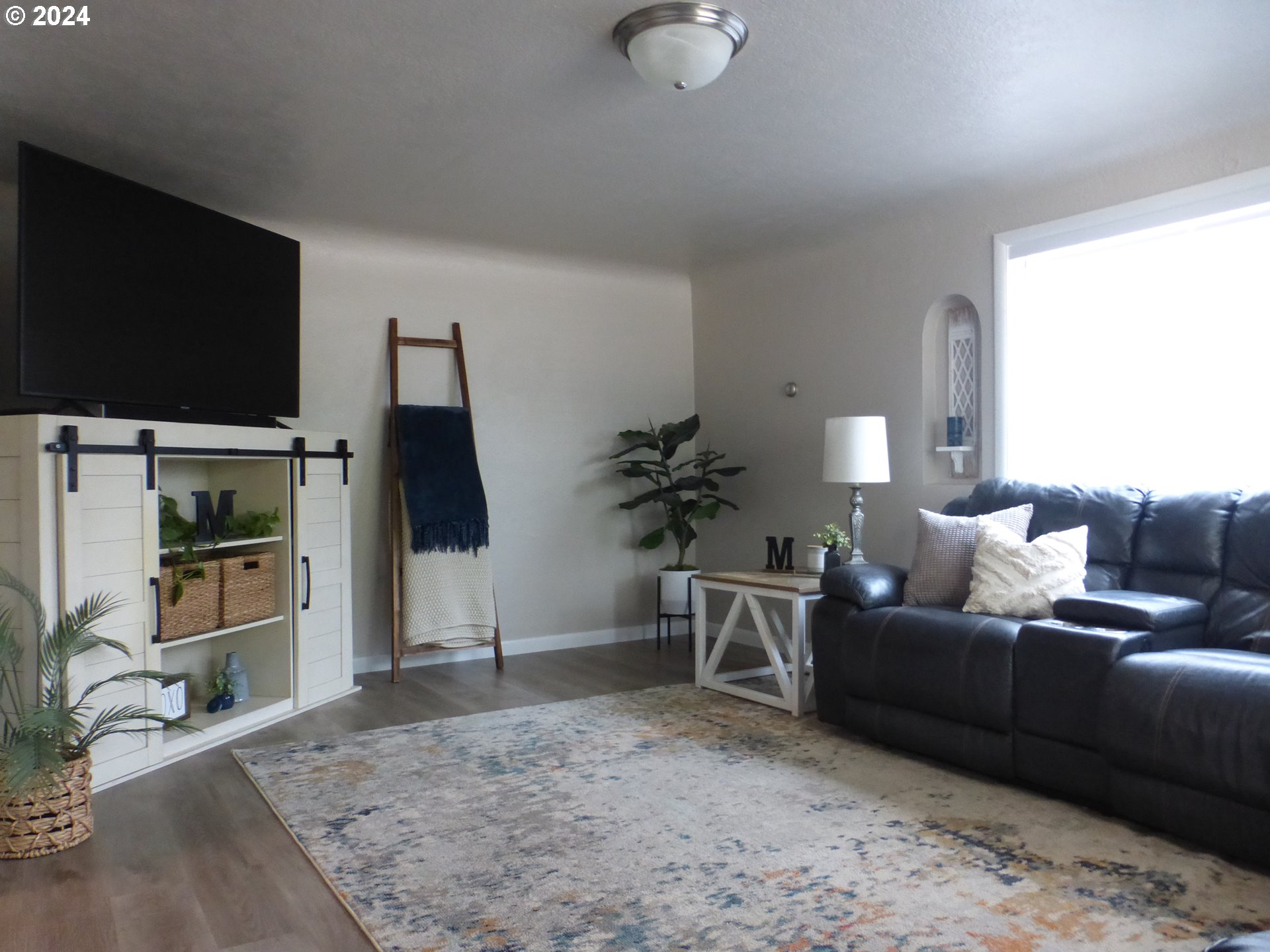 1026 M Street Springfield, OR 97477 - Photo 9 of 20 a living room with furniture and a flat screen tv