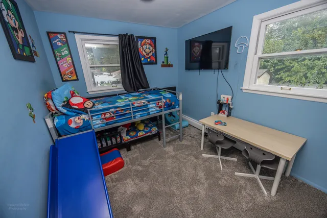 a room with furniture a flat screen tv and a window