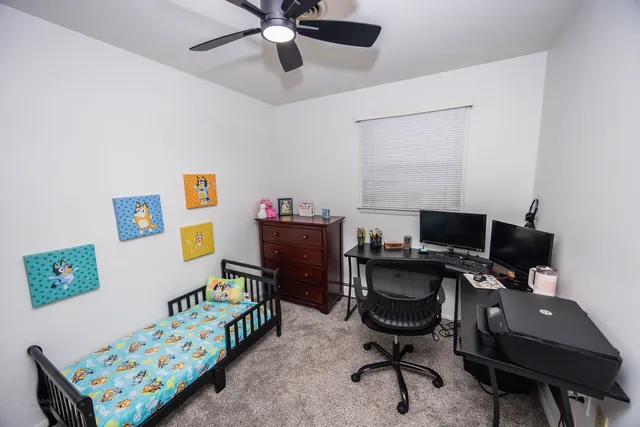 a view of a workspace with furniture and a window