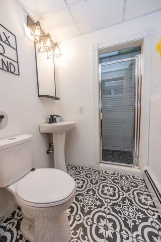 a bathroom with a toilet and a shower