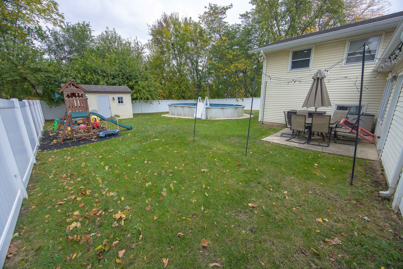 613 Westnedge Road Joliet, IL 60435 - Photo 28 of 33 a view of a backyard with table and chairs and wooden fence