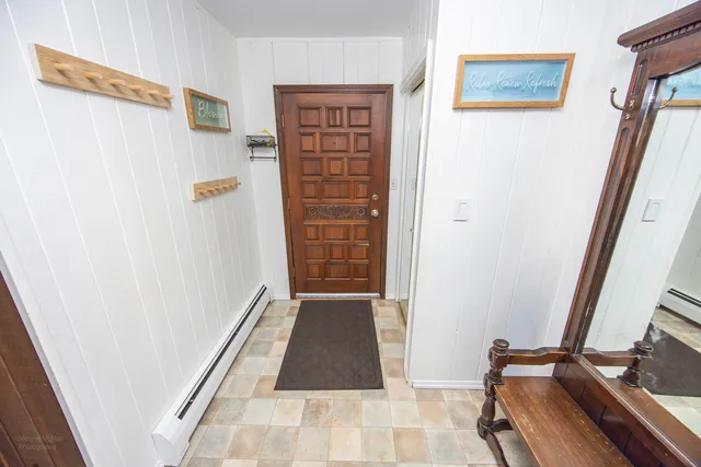 a view of a hallway with wooden floor and stairs