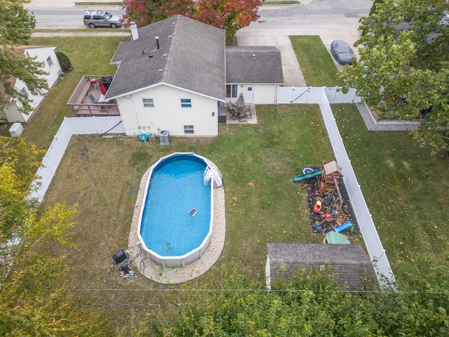 an aerial view of a house with swimming pool garden and mountain view