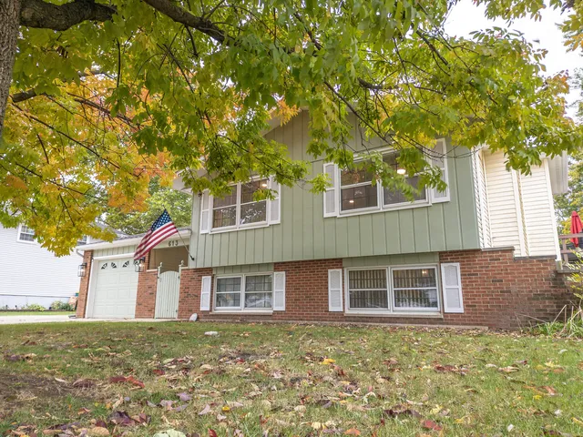 a house that has a tree in front of the house