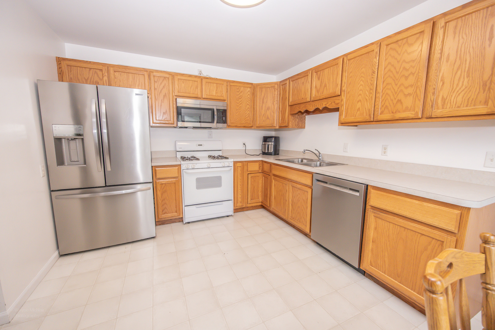 613 Westnedge Road Joliet, IL 60435 - Photo 10 of 33 a kitchen with stainless steel appliances granite countertop a refrigerator sink and cabinets