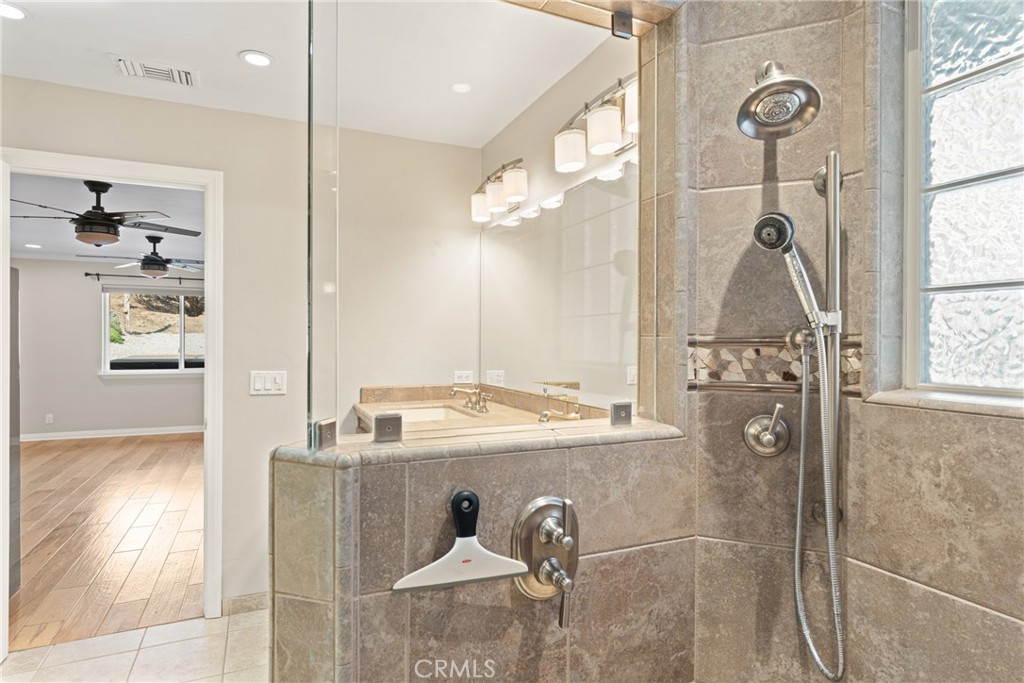 30300 Live Oak Canyon Road Redlands, CA 92373 - Photo 54 of 67 a bathroom with a sink a mirror and a shower