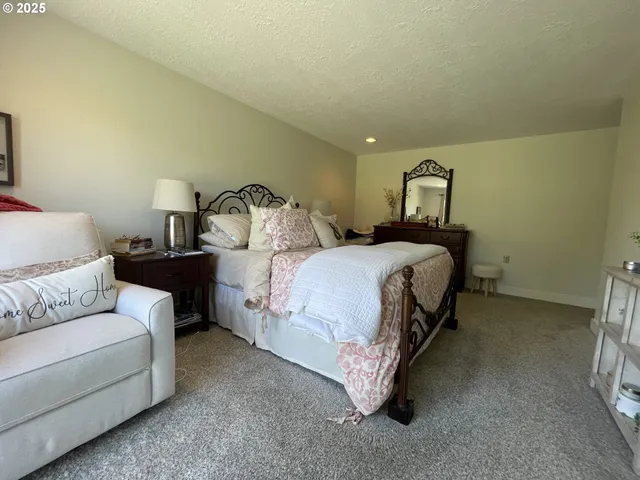 a bedroom with a bed and lamp