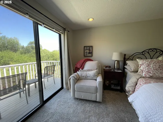 a bedroom with furniture and a large window