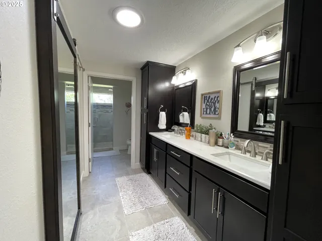 a bathroom with a double vanity sink and a mirror