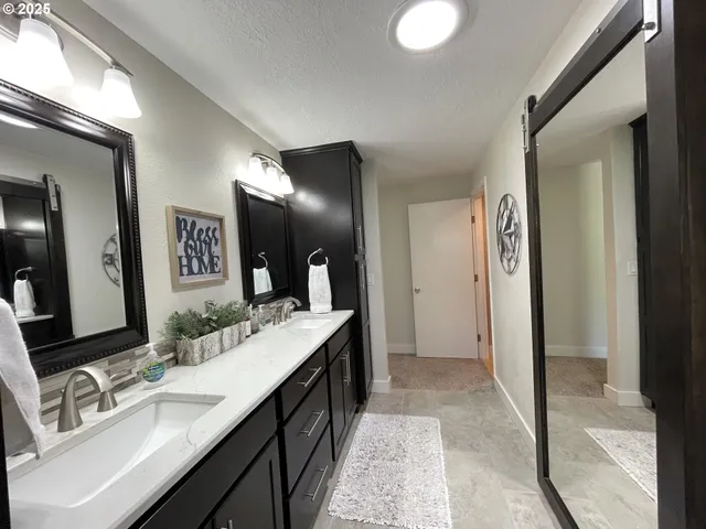 a bathroom with a double vanity sink and a mirror