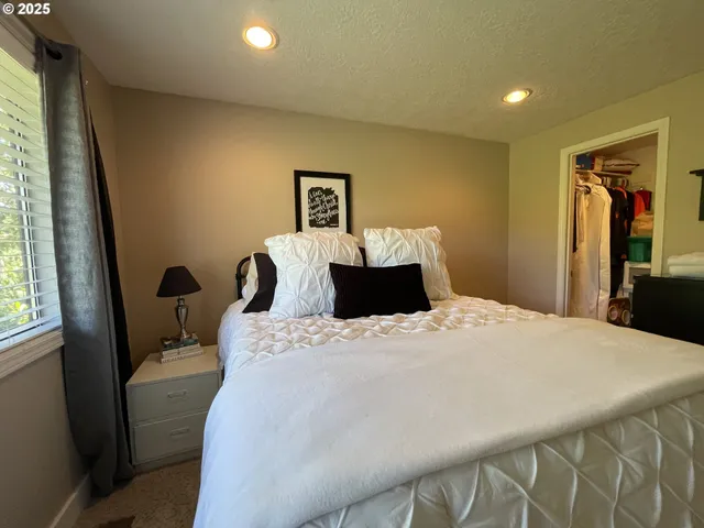 a bedroom with a bed and window