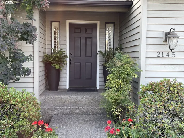 a front view of a house with plants