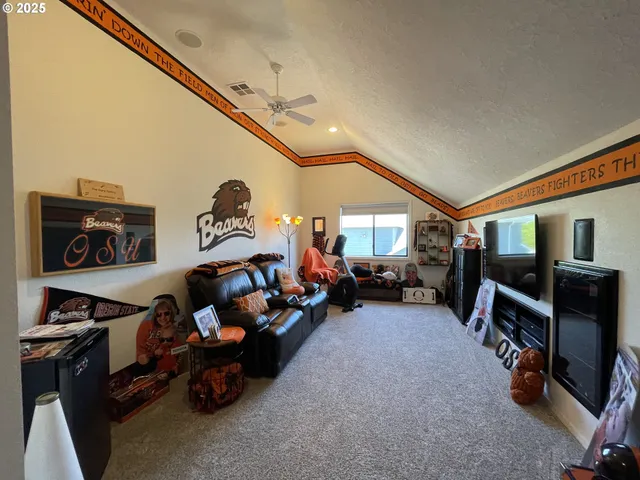 a living room with lots of furniture and a flat screen tv