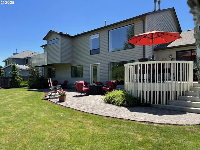 a view of a patio with a table and chairs under an umbrella
