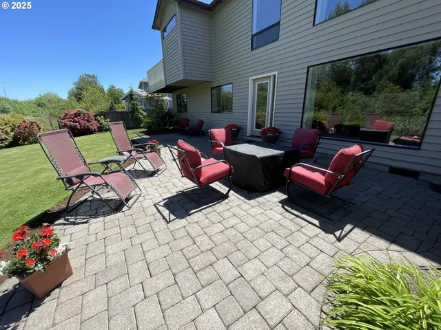 a view of a patio with couches chairs and a potted plant