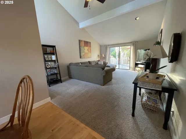 a living room with furniture a window and a flat screen tv