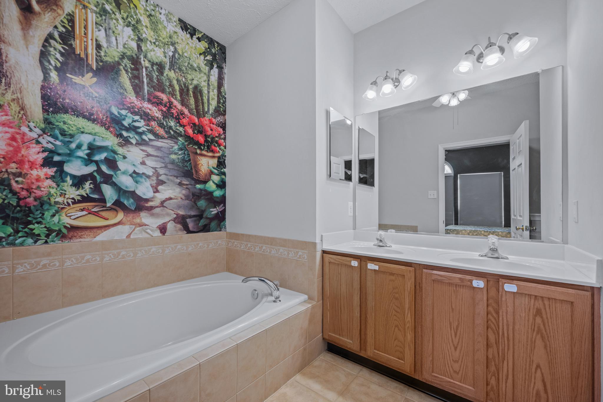 2961 Raking Leaf Drive Abingdon, MD 21009 - Photo 14 of 28 a bathroom with a bathtub a sink and a mirror