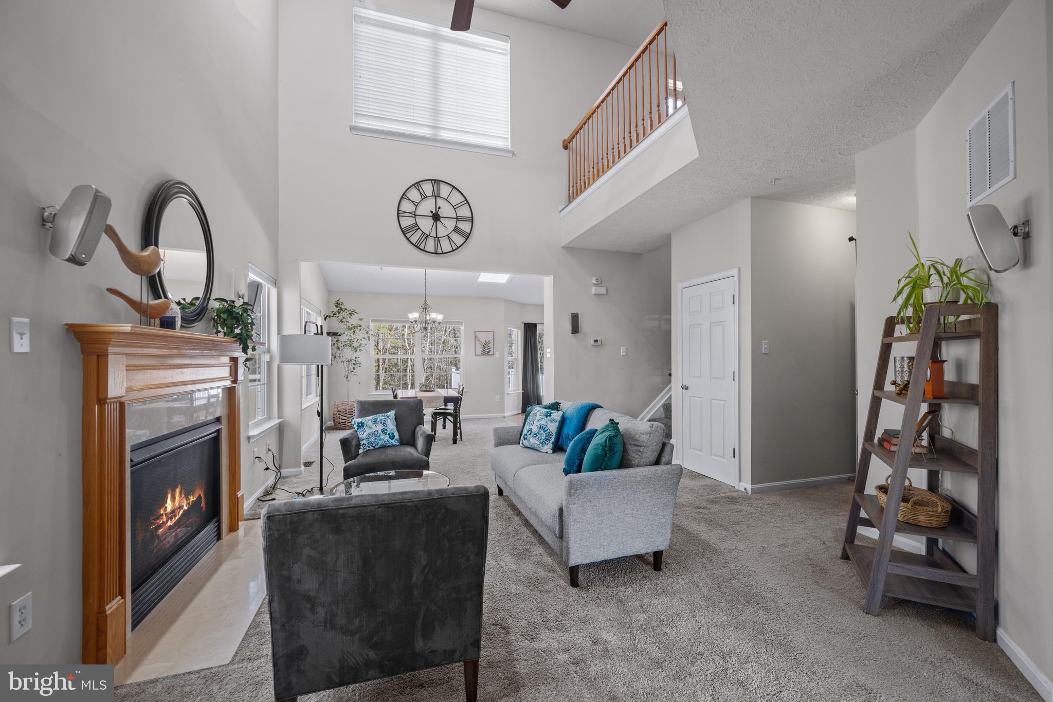 2961 Raking Leaf Drive Abingdon, MD 21009 - Photo 2 of 28 a living room with furniture a fireplace and a chandelier