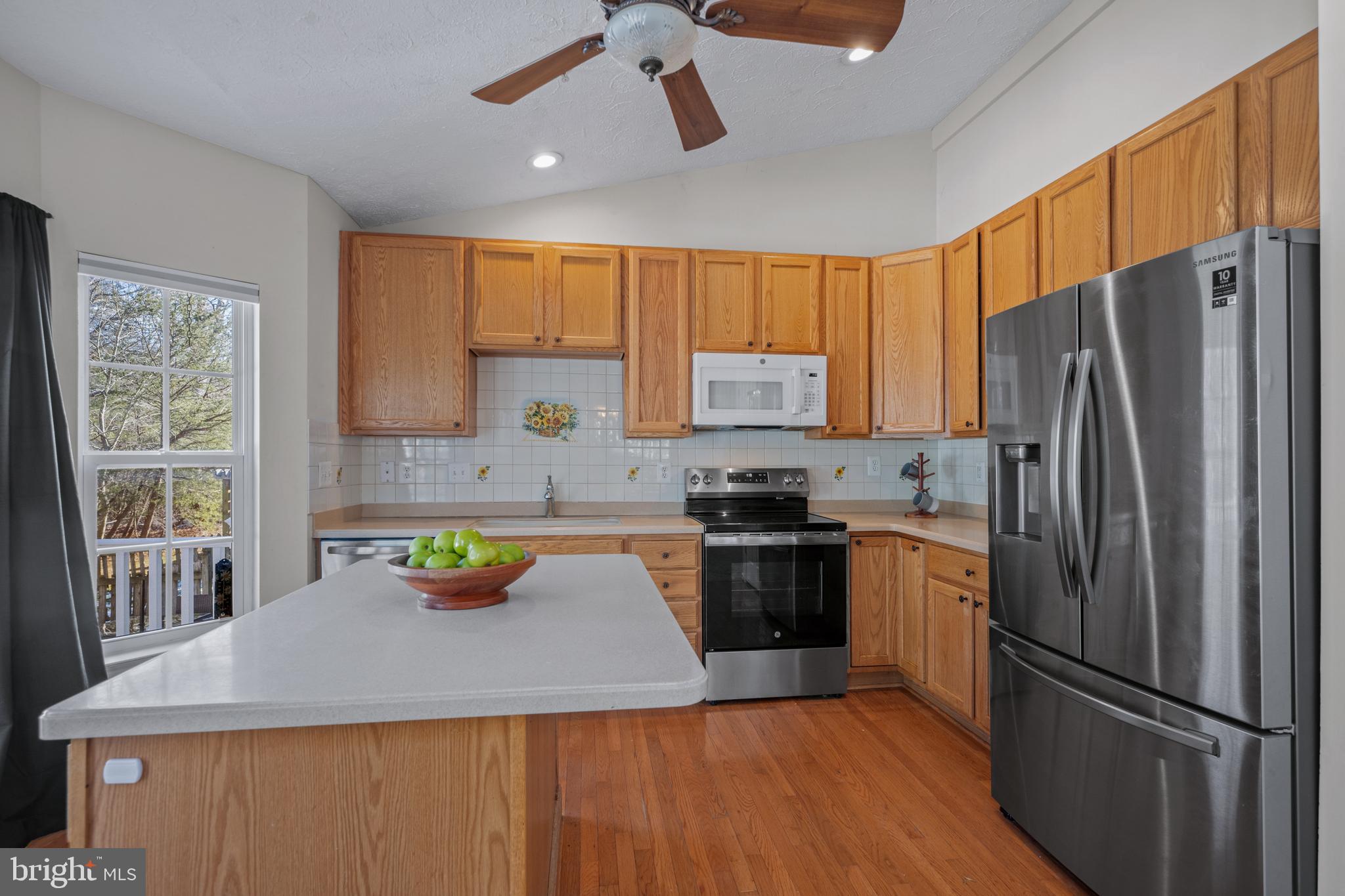 2961 Raking Leaf Drive Abingdon, MD 21009 - Photo 3 of 28 a kitchen with a refrigerator a stove a sink a center island and furniture
