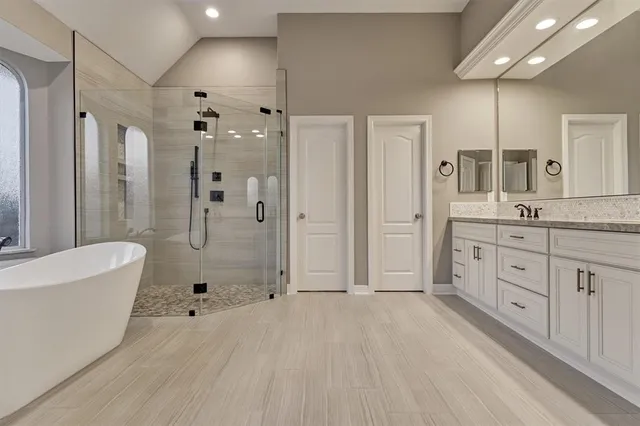 a spacious bathroom with a granite countertop sink a mirror and a