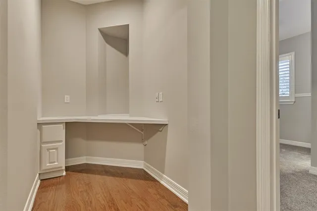 an empty room with closet and mirror