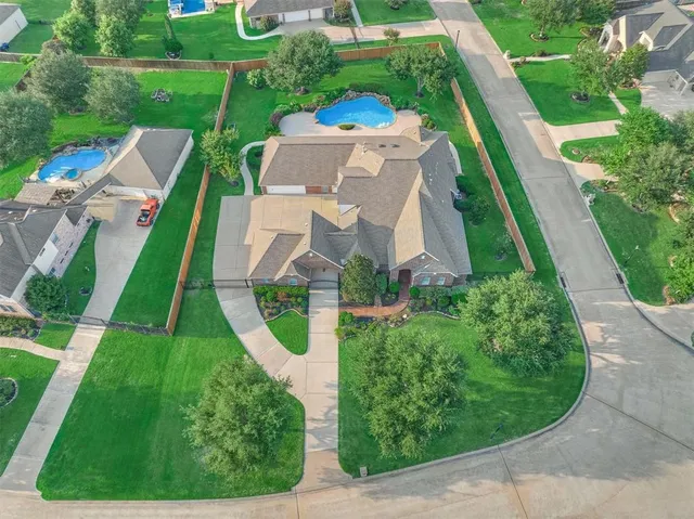 an aerial view of a house with a garden and trees