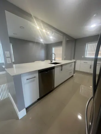 a kitchen with sink and cabinets