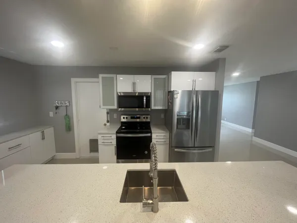 a kitchen with refrigerator and stove
