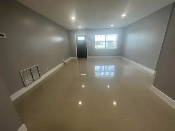 a view of an empty room with windows
