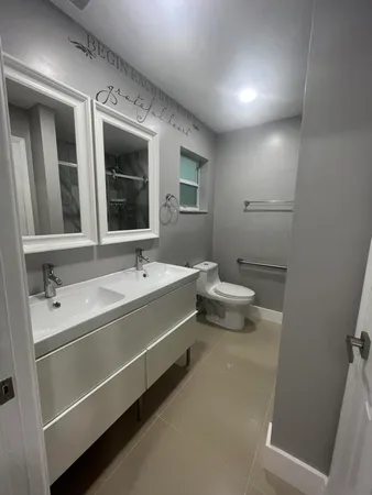 a bathroom with a double vanity sink and a mirror