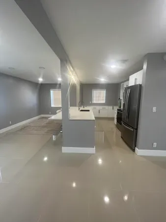 a kitchen with stainless steel appliances a refrigerator sink and microwave