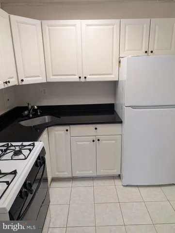 a white refrigerator freezer sitting in a kitchen